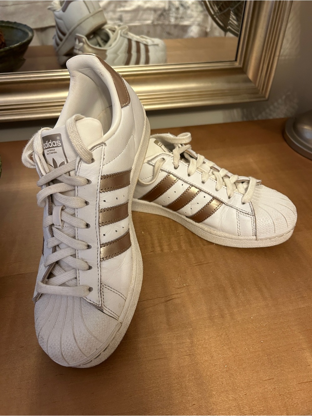 Adidas Unisex “Superstar” White Sneakers with Metallic Gold Stripes